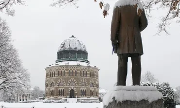 A snowy day view of the Nott Memorial, with the back of the Chester Arthur statue visible in the foreground.
