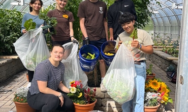 Students participating in pre-orientation 2023 work at the City Mission greenhouse, which is located at the home of David Leon '24.