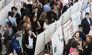 Students gather in the Wold Center Atrium for the Steinmetz Symposium poster session