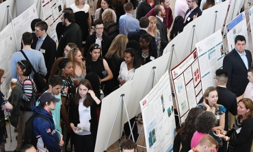 Students gather in the Wold Center Atrium for the Steinmetz Symposium poster session