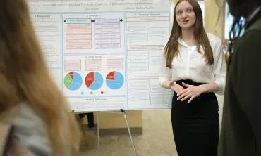 A student presents her research at the Steinmetz Symposium poster session.