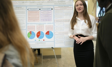 A student presents her research at the Steinmetz Symposium poster session.