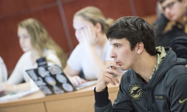  A student listens closely during a political science class at the college.