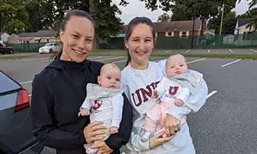 Women's head field hockey coach Kelly Harchetts with Allison (Troy) Lebowitz ‘15, and Lebowitz's twin daughters,