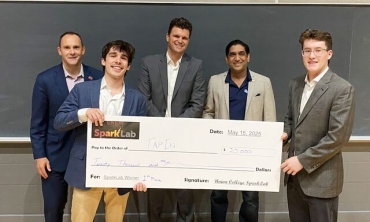 Sparklab winners hold a large faux check