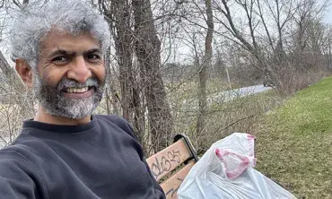Ashok Ramasubramanian helps during a trash pickup event along the Mohawk-Hudson Bike Hike Trail.