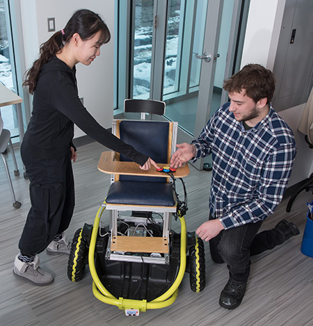 Engineering students Yueyin Su and Benjamin Davis collaborate on the replicable power wheelchair.