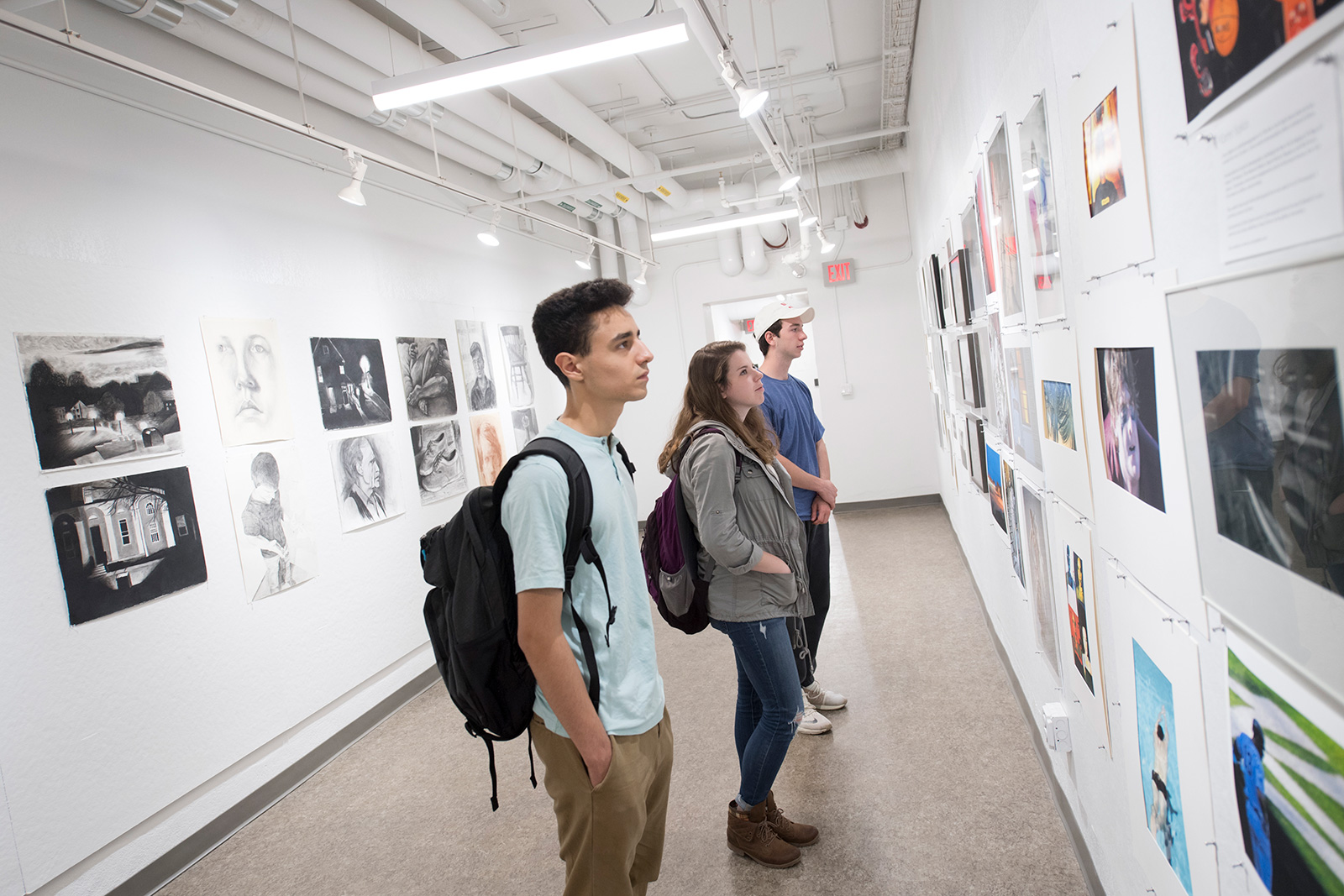 Students looking at art on display at the Feigenbaum Center for Visual Arts.