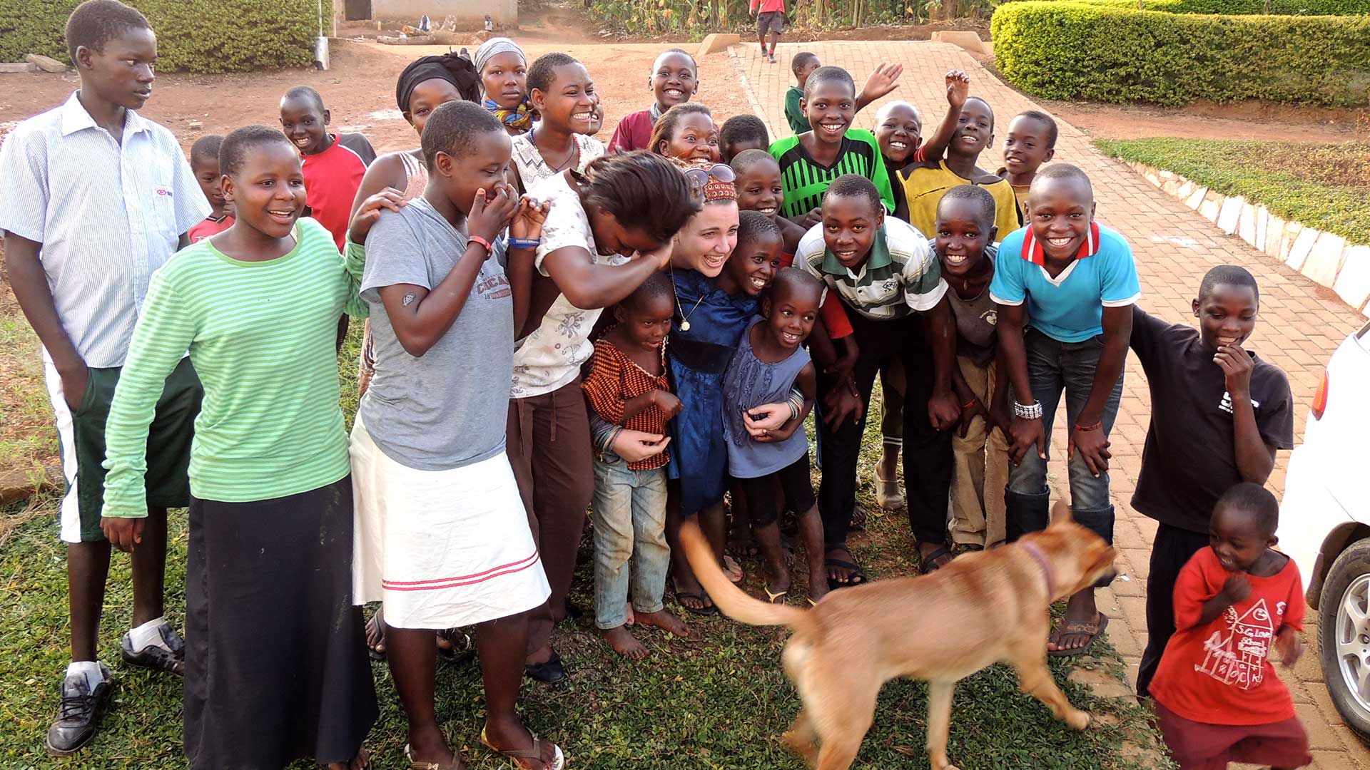 A Union student participating in a study abroad program alongside a group of Kenyan children.