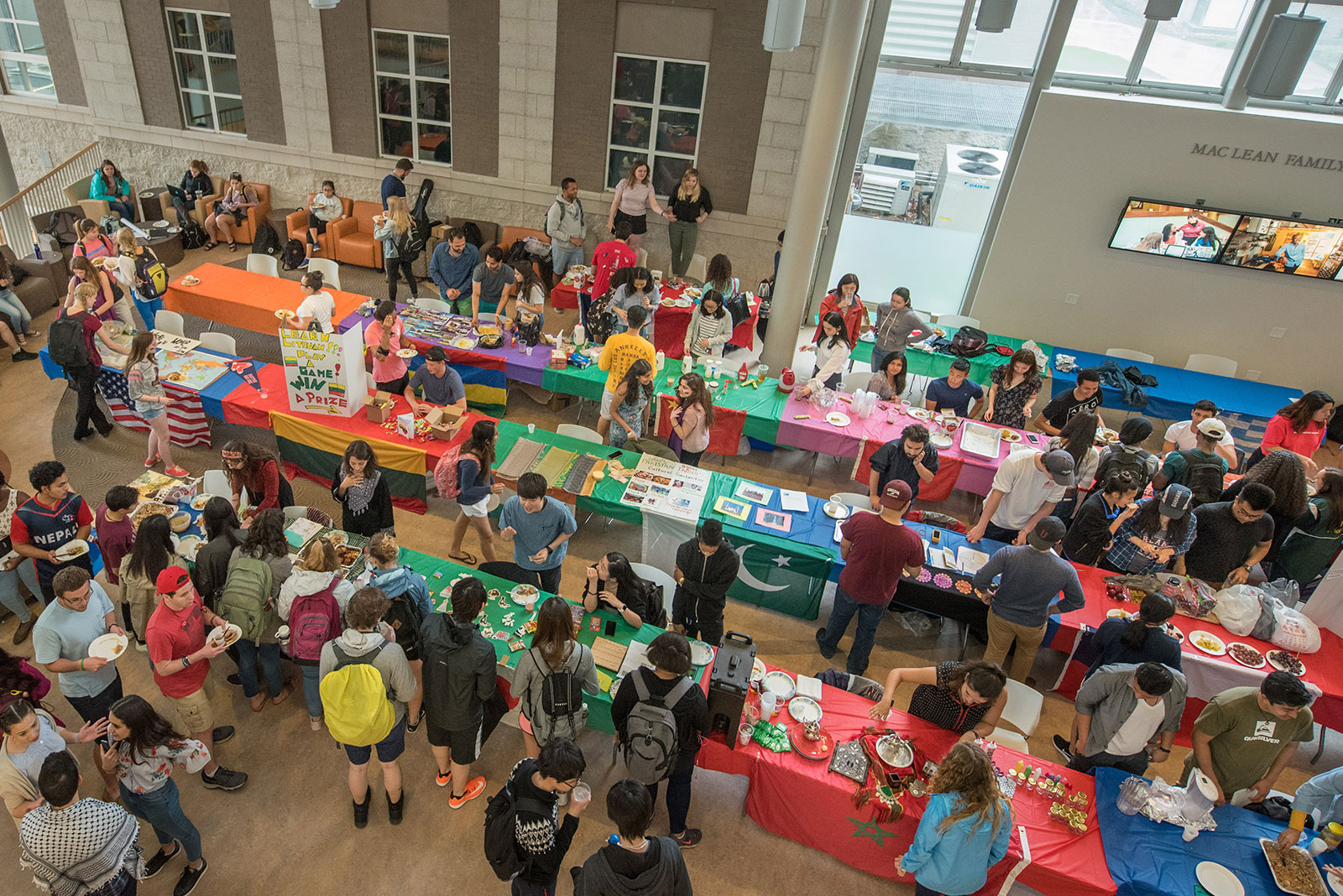 A view of the International Fair with tables and food all set up in the Wold Center atrium.