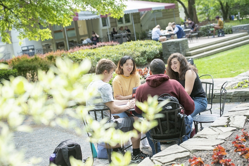 Students enjoying a nice day in the back of Reamer Campus Center.